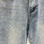 Louis Vuitton denim fabric close-up, light blue monogram print, stitched seam