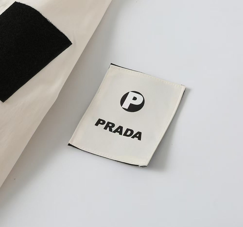Prada logo label patch on white fabric near the garment hem
