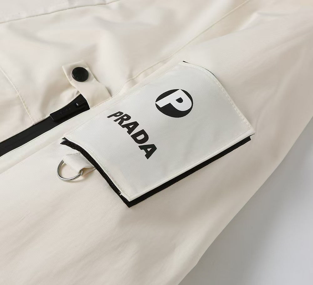 Prada logo tag on white jacket pocket opening with black trim