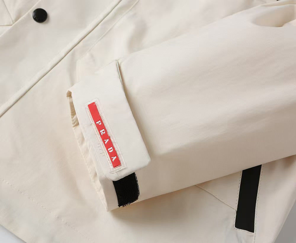 Prada long jacket sleeve close-up with red Prada brand fabric tab