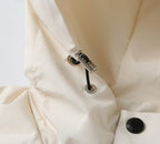 Prada long jacket zipper pull close-up with metal hardware and black accent