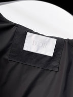 Black long clothing with Dior logo label on fabric