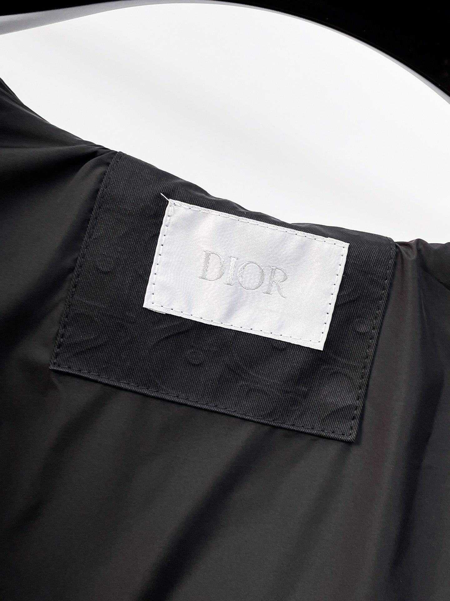 Black long clothing with Dior logo label on fabric