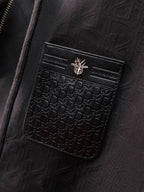 Dior long jacket, close-up of black embossed logo pocket with flap and snap