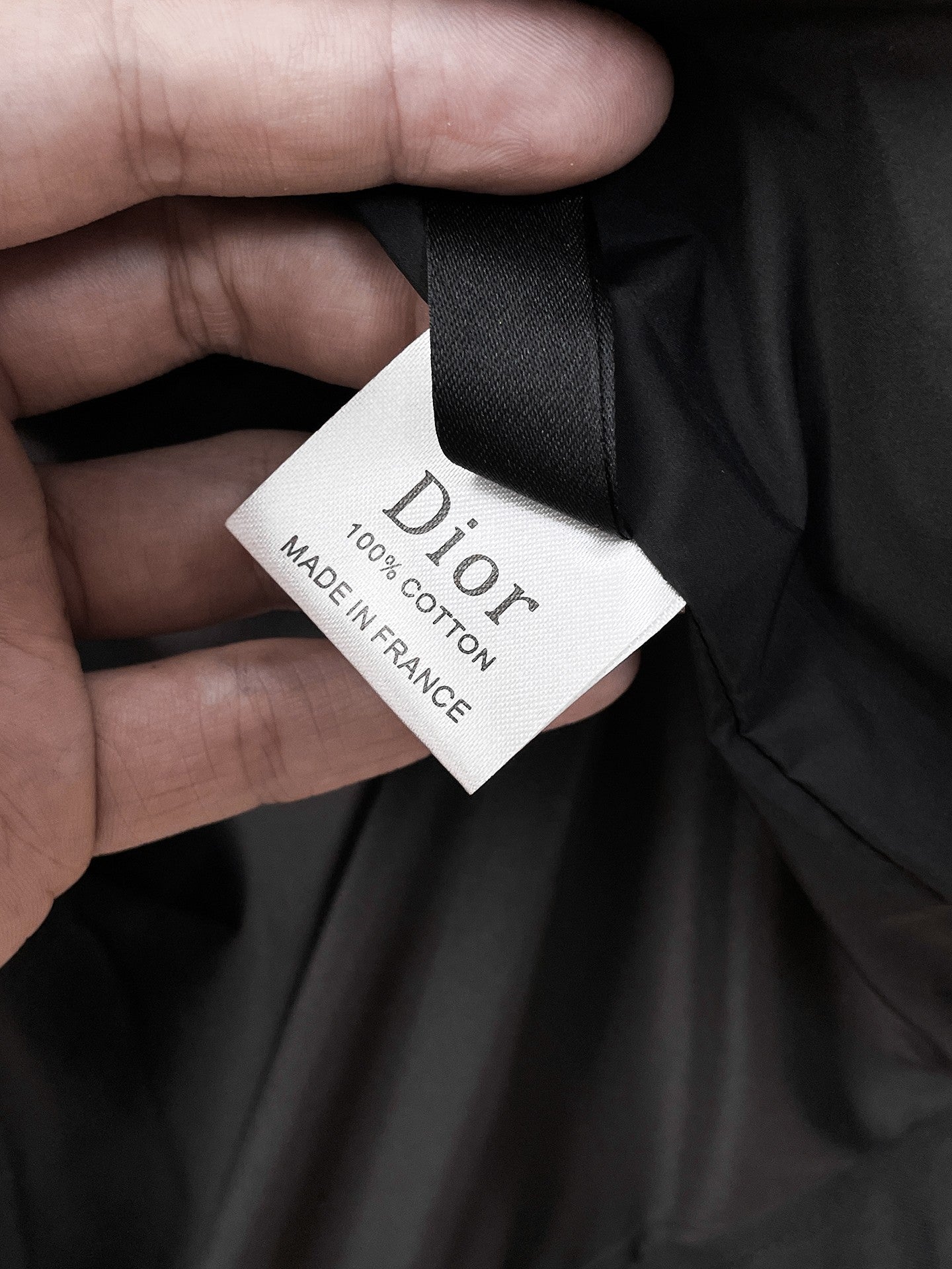 Black long clothing with Dior care label, Made in France tag