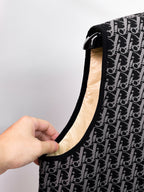 Close-up of black sleeveless vest neckline edge and beige lining