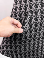 Close-up of black Dior monogram patterned fabric