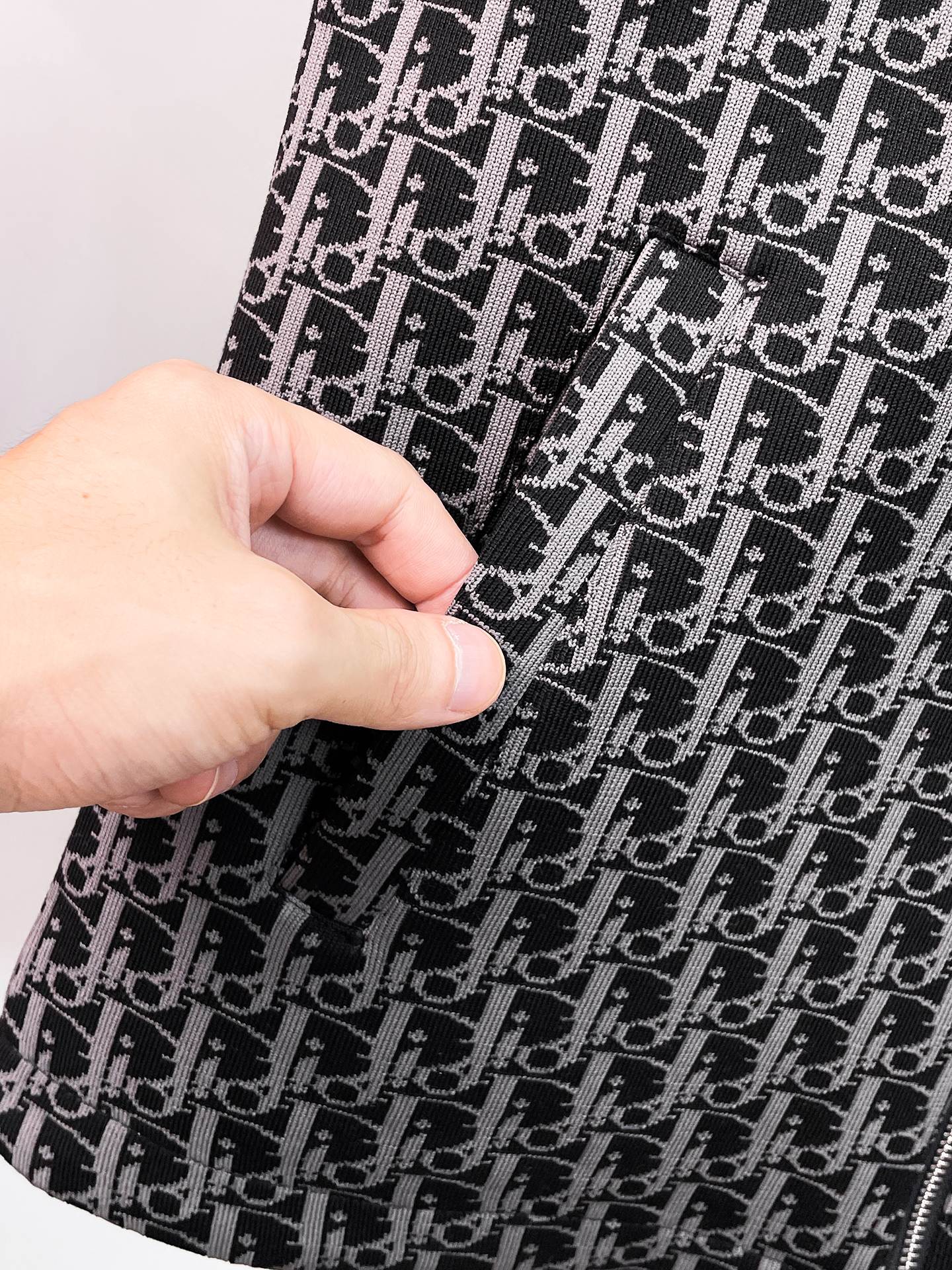 Close-up of black Dior monogram patterned fabric