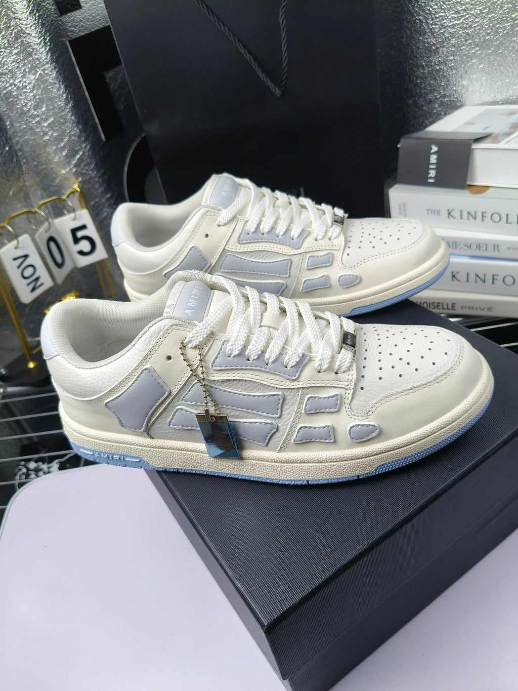 Amiri lace-up sneakers, white leather with light-blue logo stripes and decorative emblem