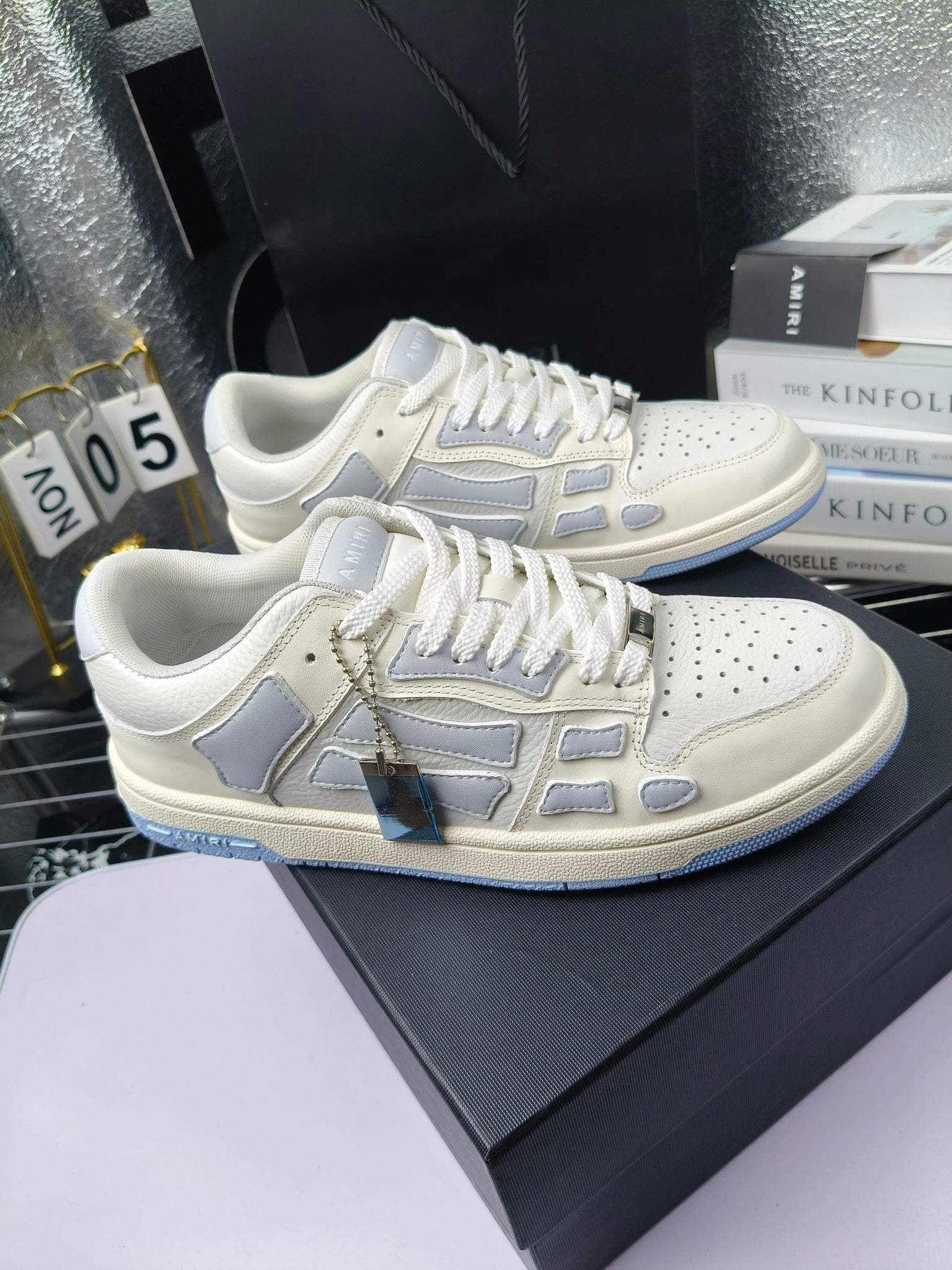 Amiri lace-up sneakers, white leather with light-blue logo stripes and decorative emblem
