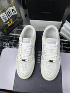 Amiri lace-up sneakers pair, white leather uppers with blue logo accents