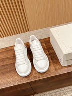 Pair of white lace-up sneakers with smooth toe cap and cushioned sole, Alexander McQueen