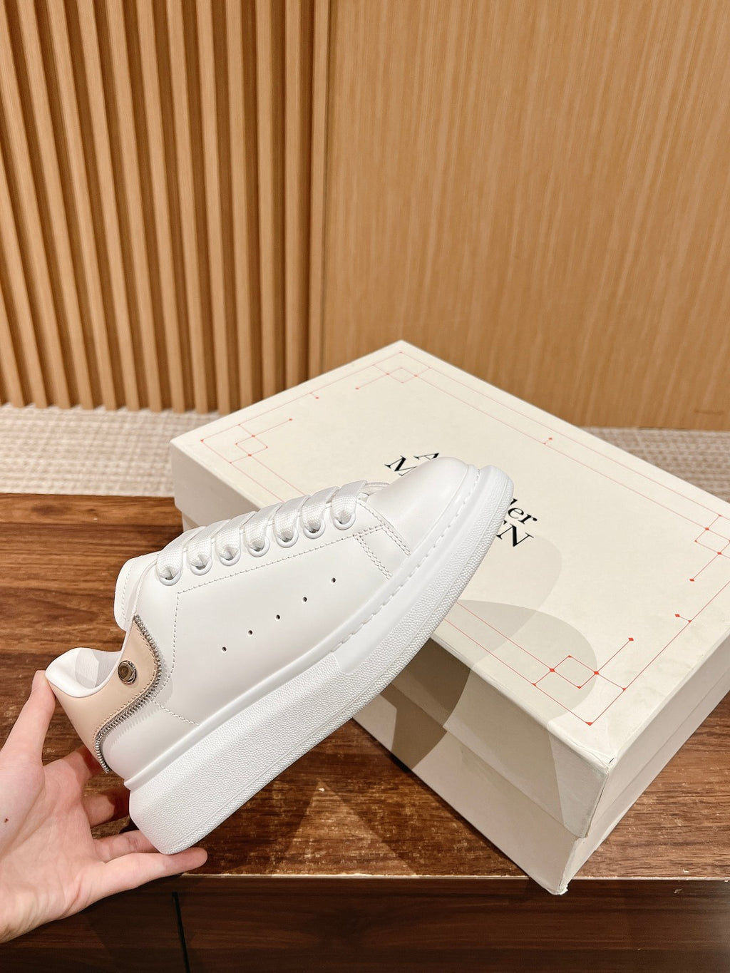 White leather sneakers with lace-up eyelets and low-profile rubber sole, Alexander McQueen