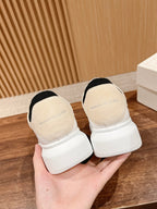 White leather sneakers with black heel lining and cushioned heel tab