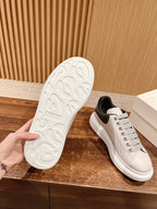 White rubber outsole tread with white and gray sneaker side view.