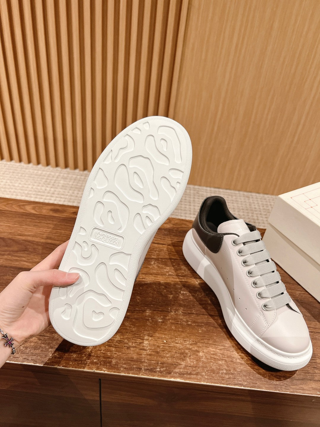 White sneaker outsole with textured tread and side view of lace-up upper
