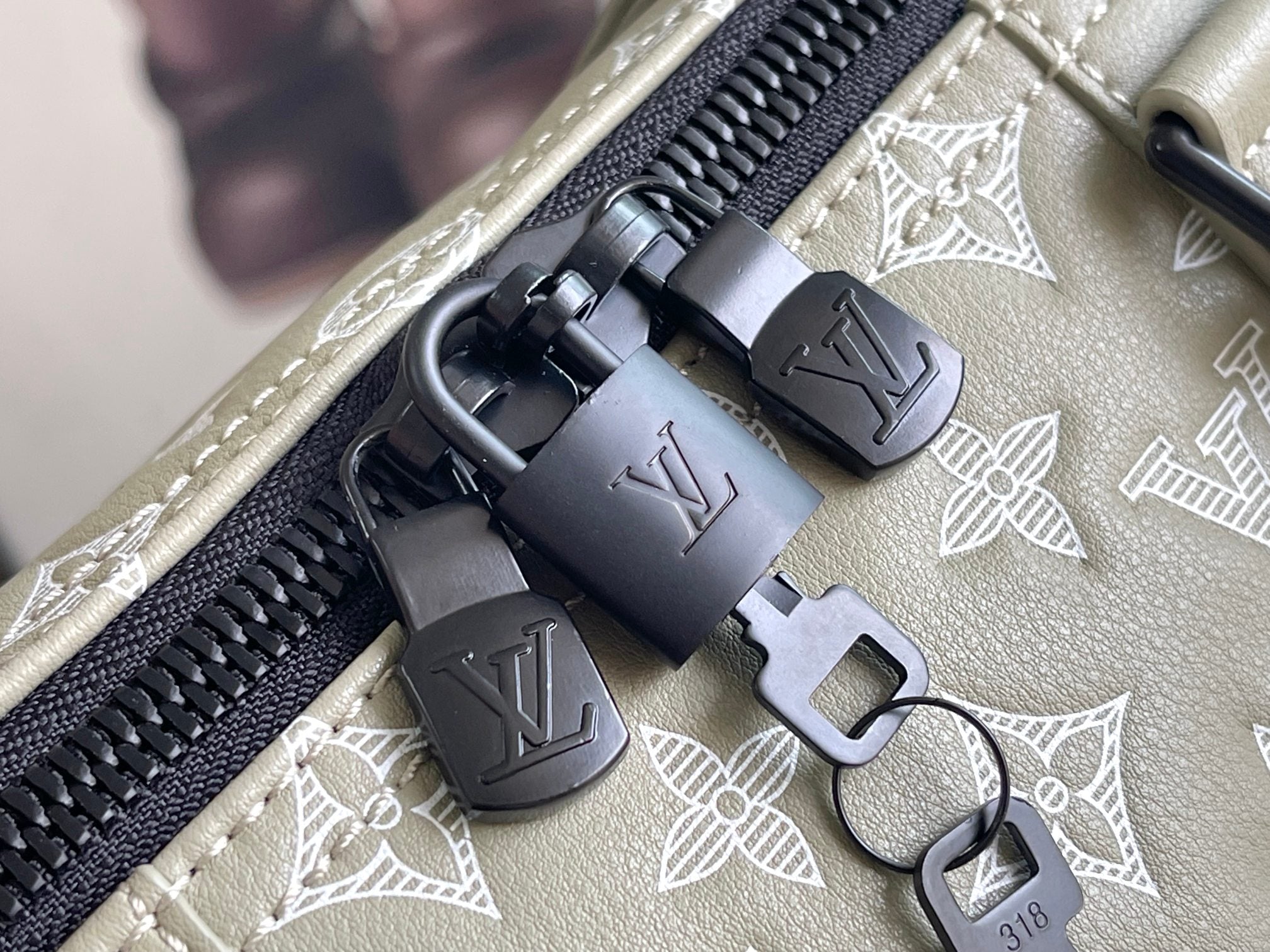 Louis Vuitton monogram bag zipper pull with hardware and key fob, beige leather