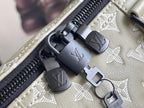 Louis Vuitton duffel bag zipper with black leather pull tabs and logo hardware on monogram canvas