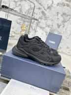 Charcoal gray lace-up sneakers with sculpted side overlays, displayed at an angle