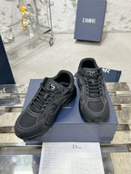Charcoal gray lace-up sneakers with stitched panel detailing, on a blue box
