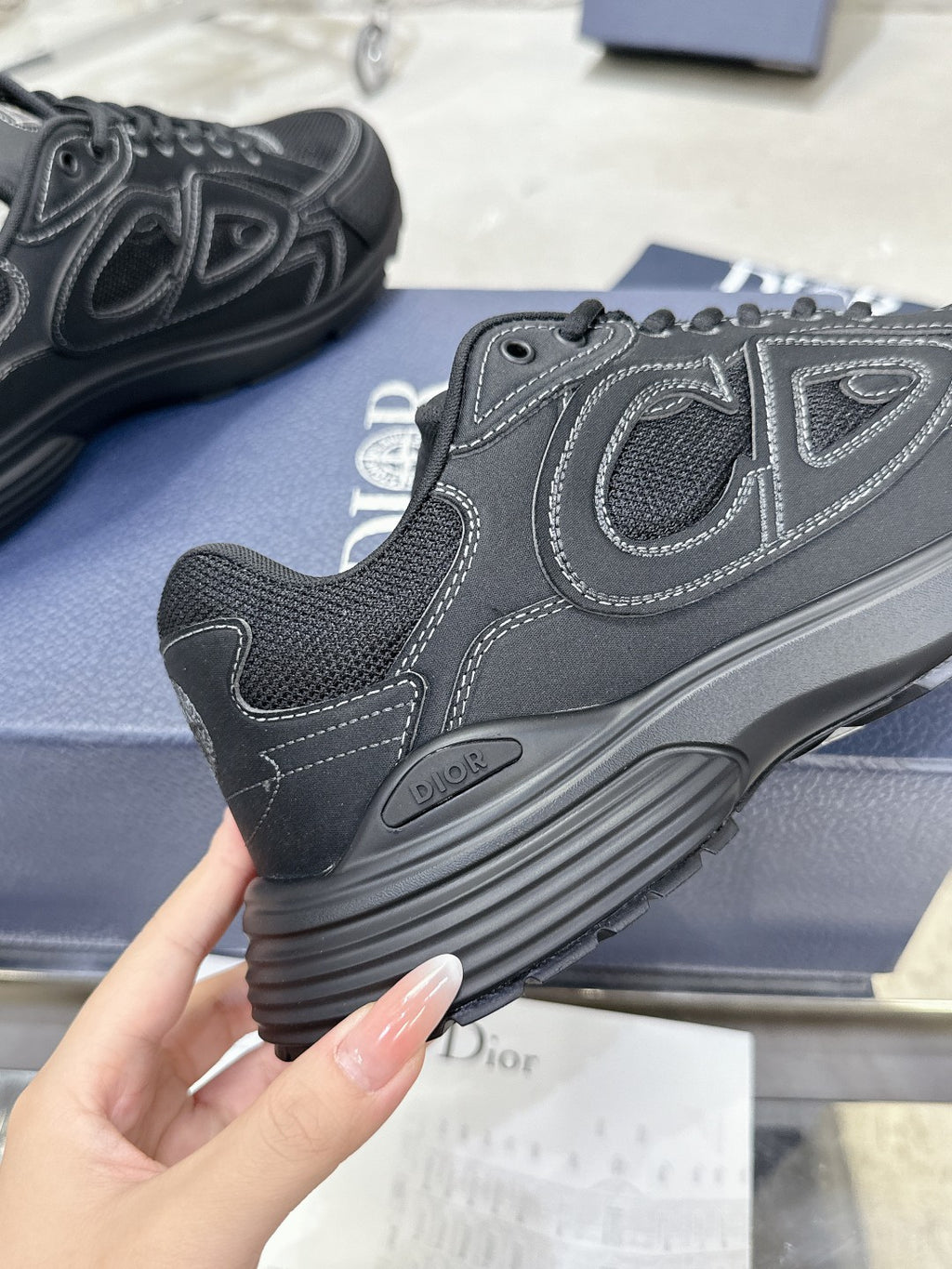 Charcoal gray sneaker toe and side detail with lace-up eyelets and rubber sole