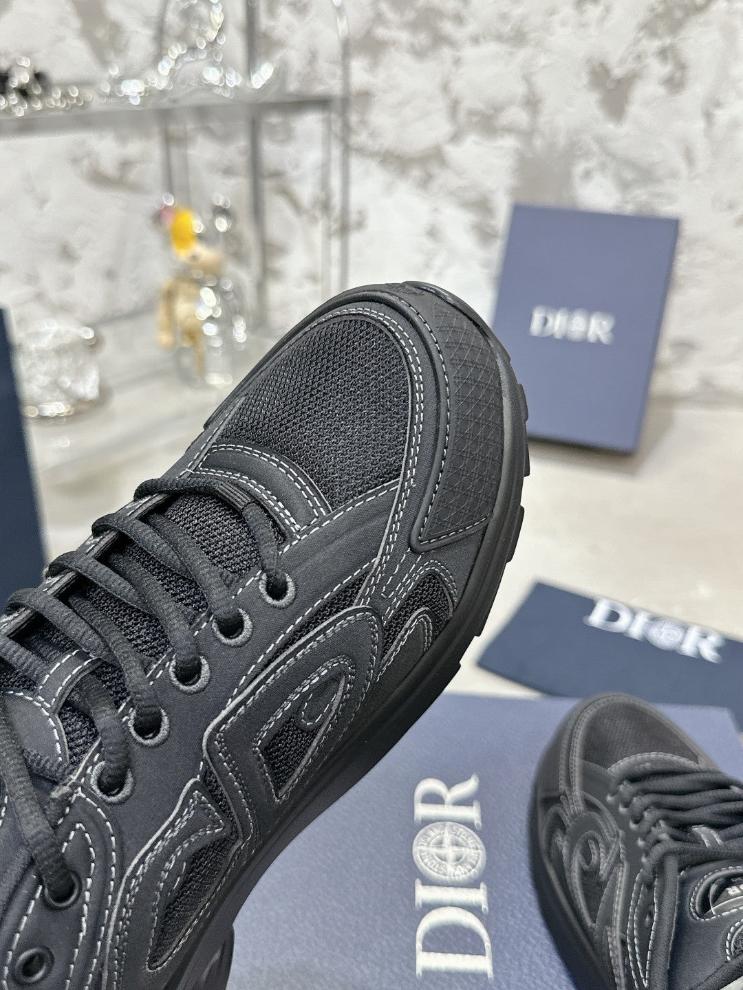 Charcoal gray lace-up sneaker side view with contrast stitching and textured upper