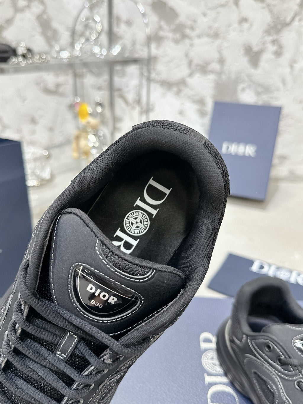 Charcoal gray sneaker with branded tongue lining and lace-up front, close-up