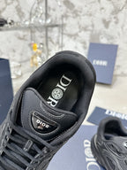 Charcoal gray sneaker with branded tongue lining and lace-up front, close-up