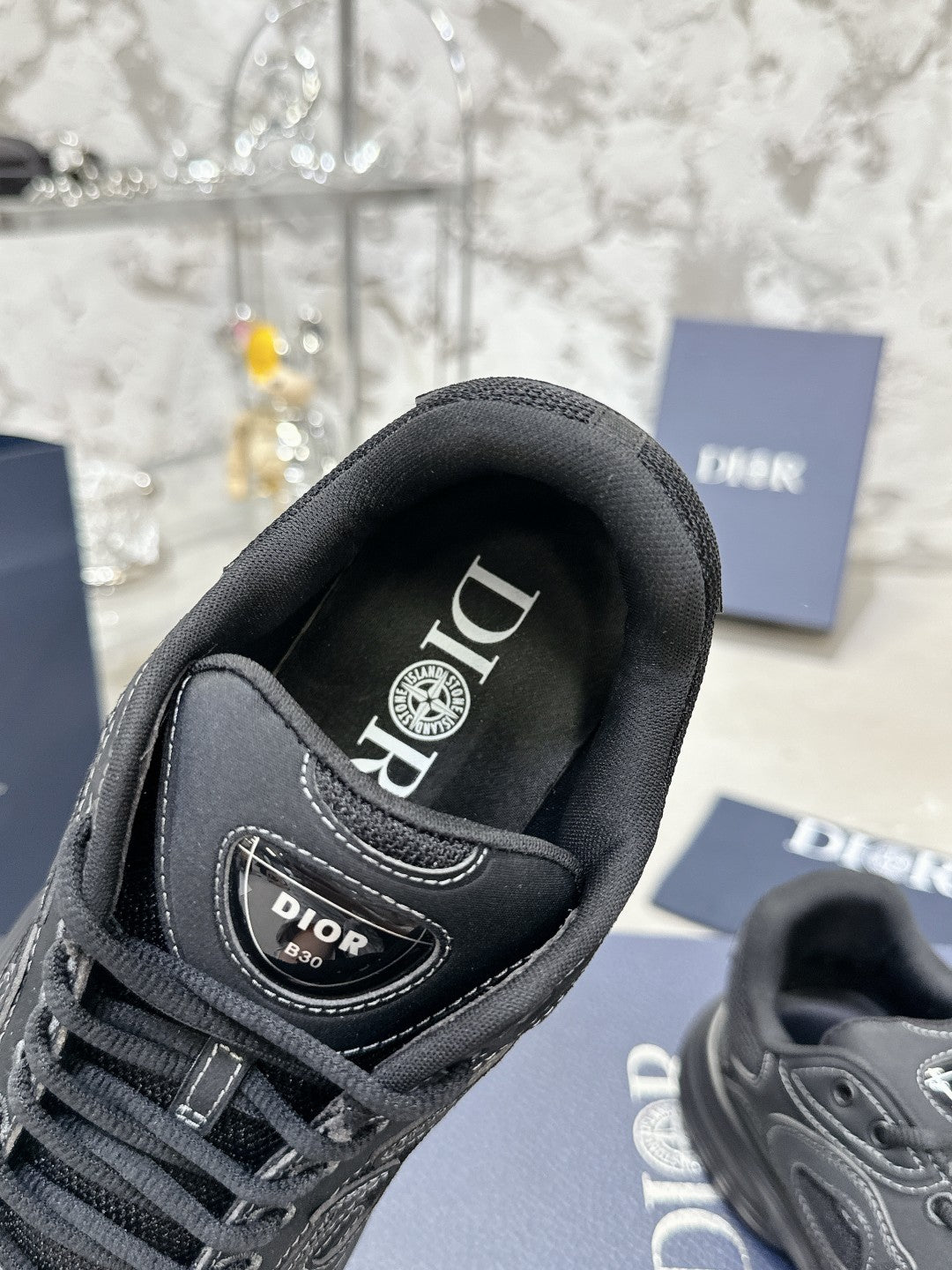 Charcoal gray sneaker with branded tongue lining and lace-up front, close-up