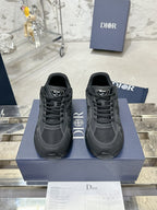 Charcoal gray lace-up sneakers, front view on a blue display box