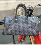 Top-handle tote bag with gray-blue patterned canvas and two front strap tabs
