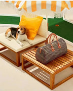 Brown patterned top-handle tote bag with leather handles and zipper top