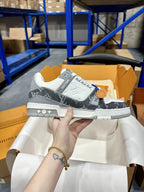 White and dark monogram low-top Louis Vuitton trainer shoes, lace-up, rubber sole.