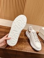 White sneaker outsole view with textured tread and lace-up upper