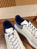 Alexander McQueen low-top sneakers pair, white with blue collar and check laces