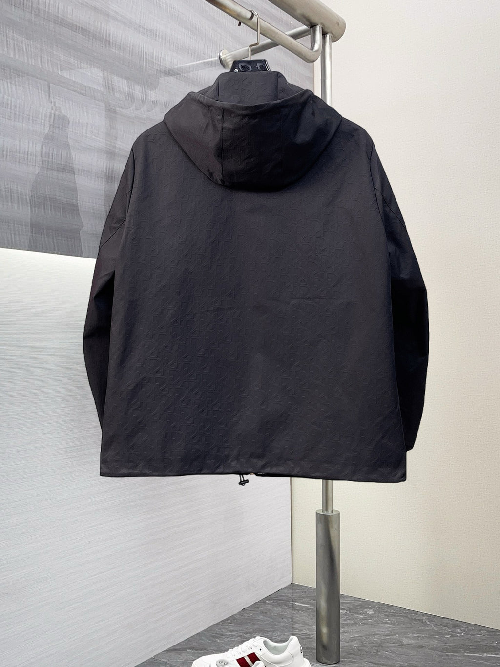 Dior long jacket, black hood with full back coverage and zip-front silhouette