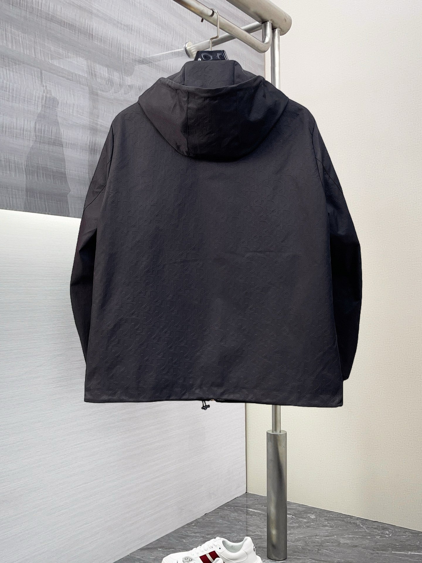 Dior long jacket, black hood with full back coverage and zip-front silhouette