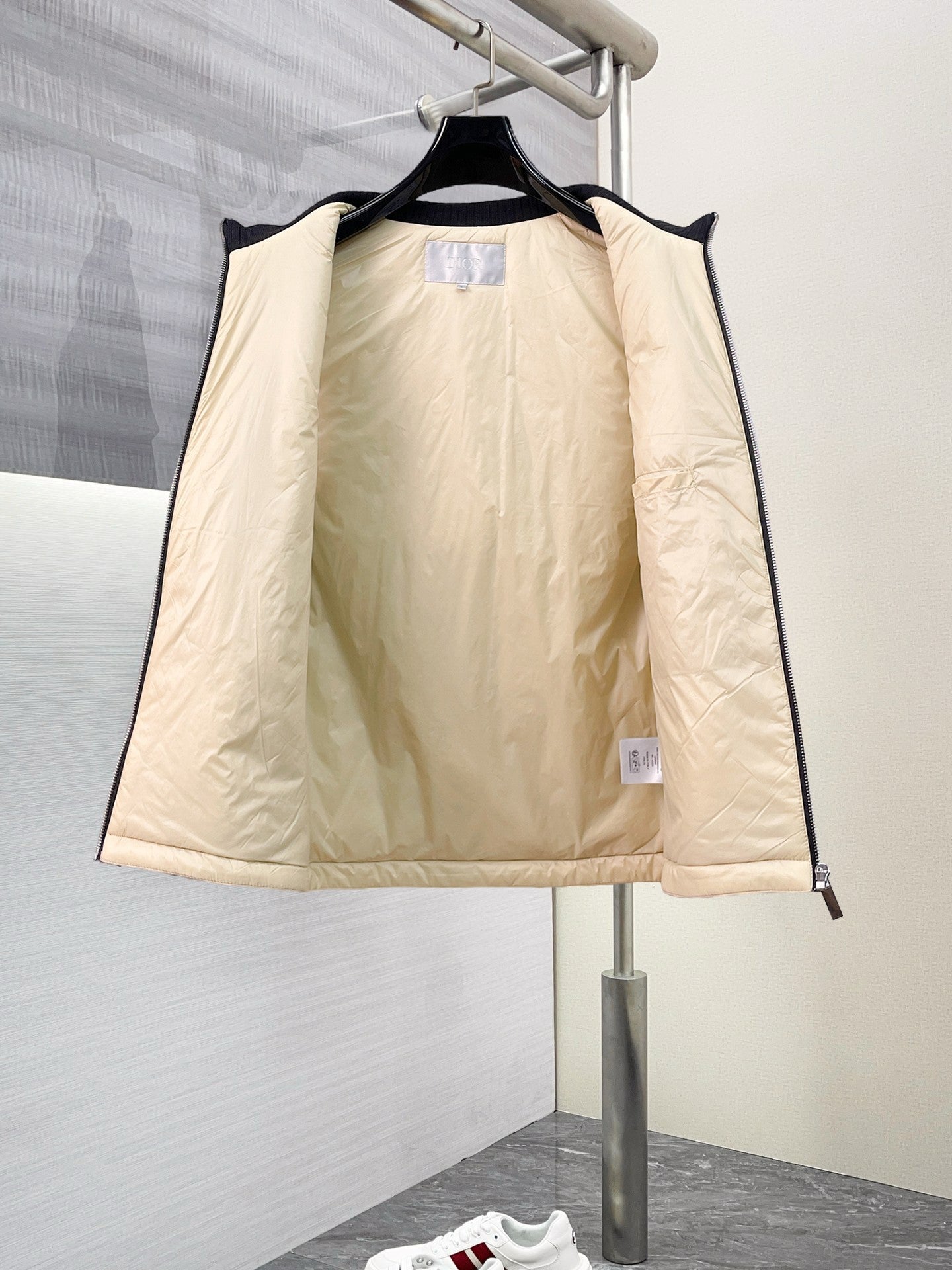 Beige sleeveless vest with drawcord hem and front zip