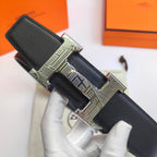 Hermes belt angled view: black leather with silver-tone buckle and stitched edge