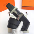 Hermes belt with textured black leather and silver-tone geometric buckle detail