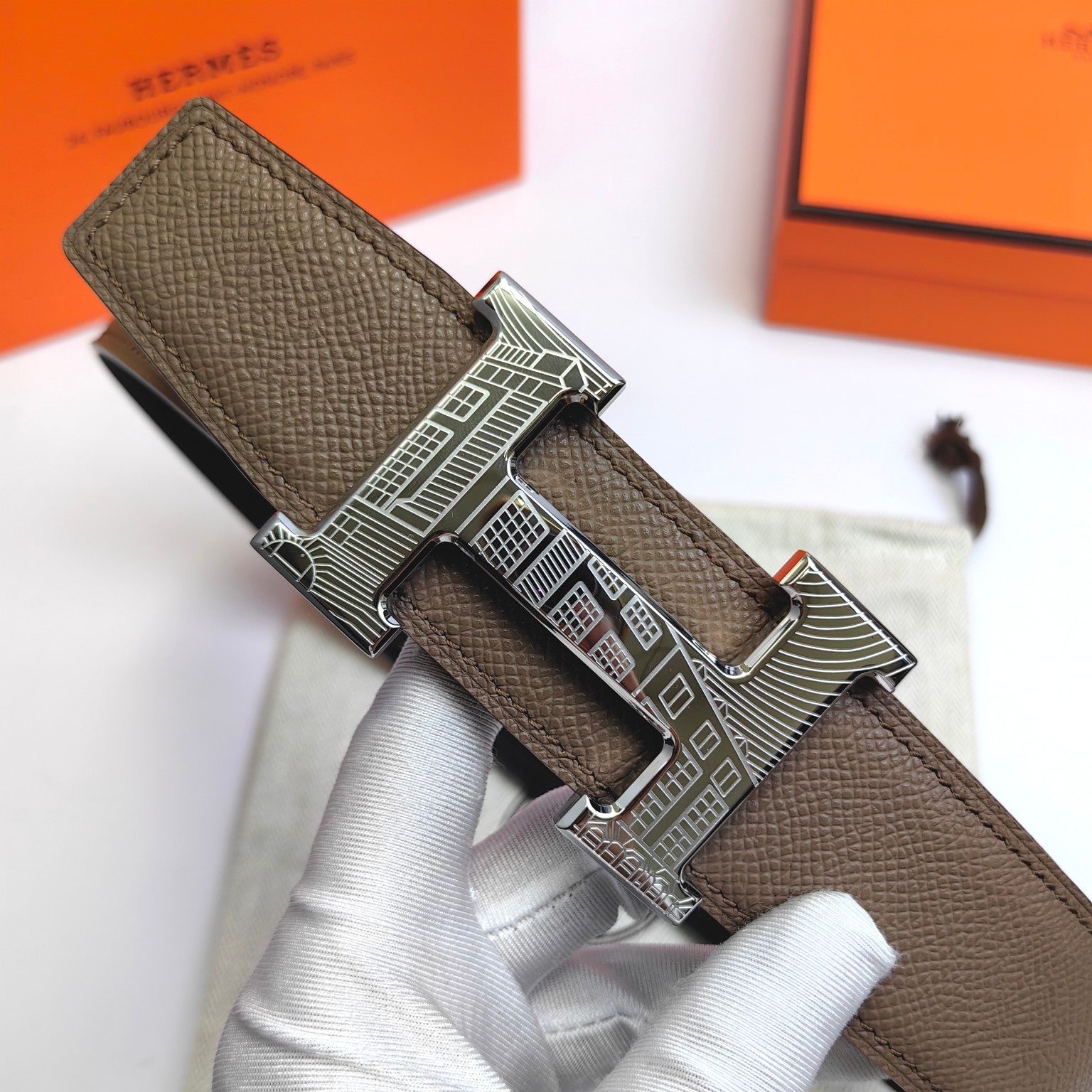Olive leather belt with silver-tone geometric buckle and adjustable holes