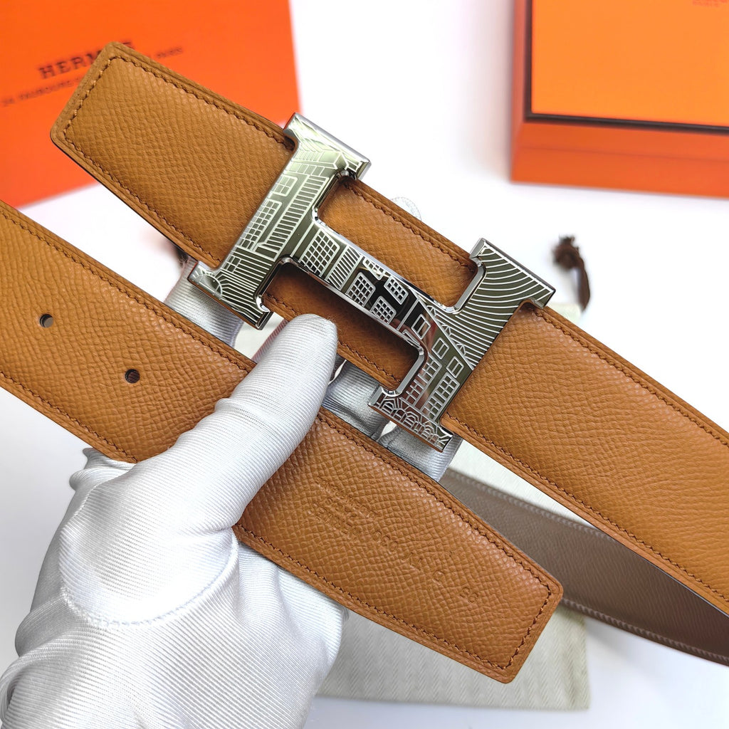 Leather belt showing tan strap and silver-tone buckle with cutout design