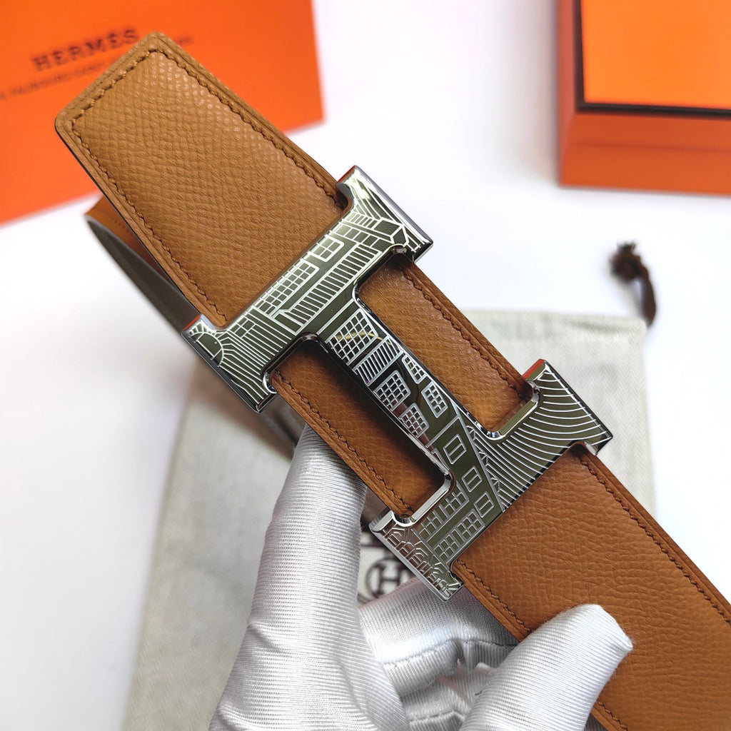 Leather belt with tan textured strap and silver-tone buckle, strap looped