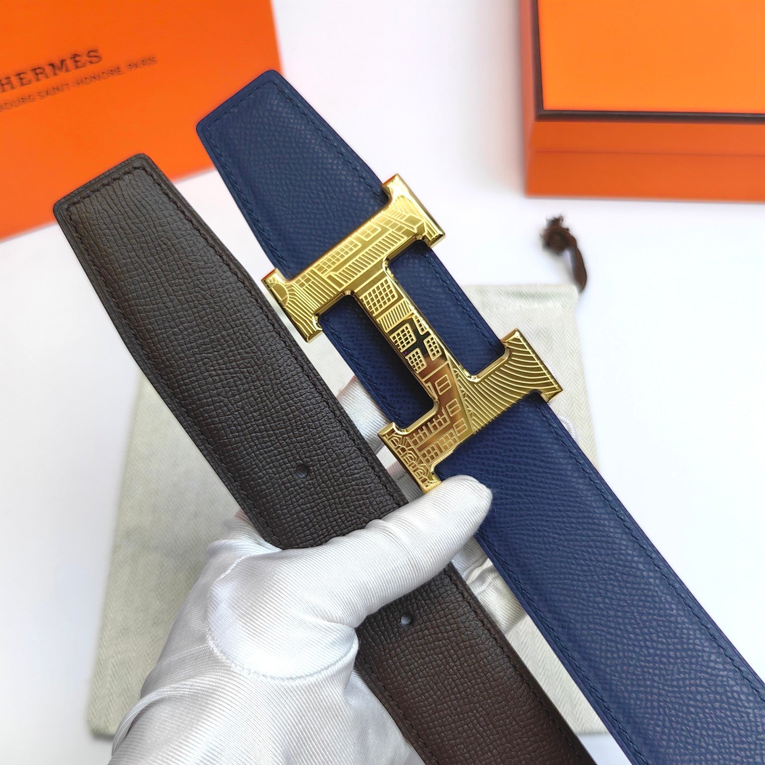 Hermes belt with blue and dark brown straps and gold H buckle
