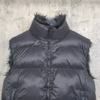 Navy puffer vest close-up with faux-fur collar trim and zip-front quilted design