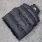 Navy sleeveless puffer vest laid flat with faux-fur trim and side zipper panel