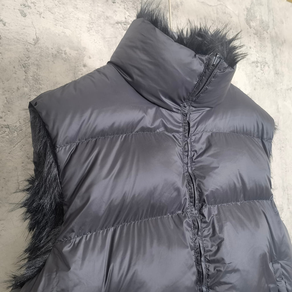Navy puffer vest with faux-fur side trim and centered zipper front detail
