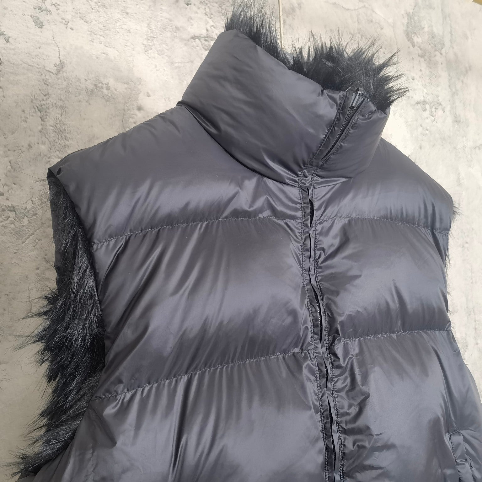 Navy puffer vest with faux-fur side trim and centered zipper front detail