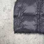 Navy puffer vest sleeve opening and faux-fur hem trim with zip-front seam