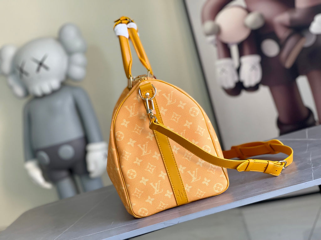 Louis Vuitton monogram satchel with top handle and yellow shoulder strap